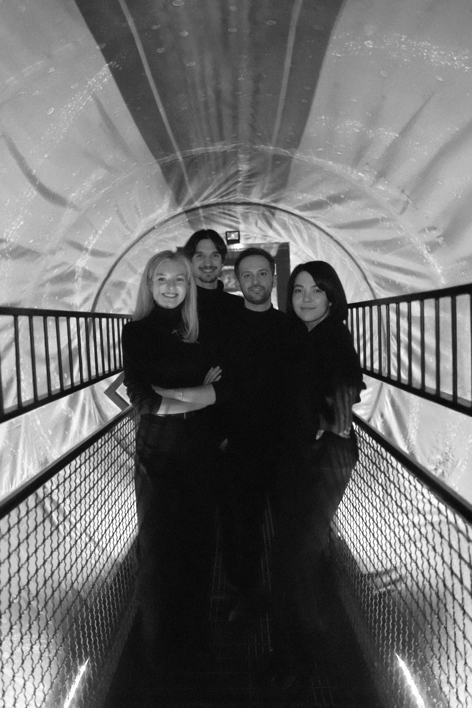 full body portrait of the wohle crew standing in a futuristic tube