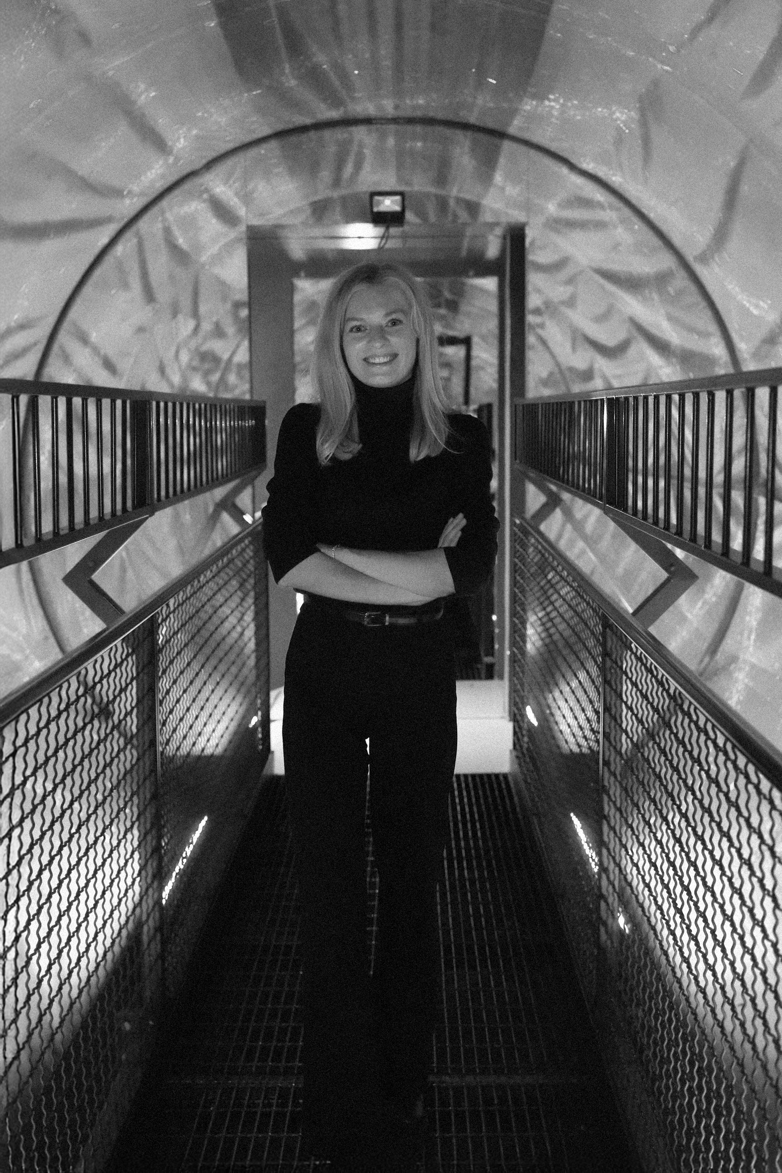full body portrait of Greta Bastian standing in a futuristic tube