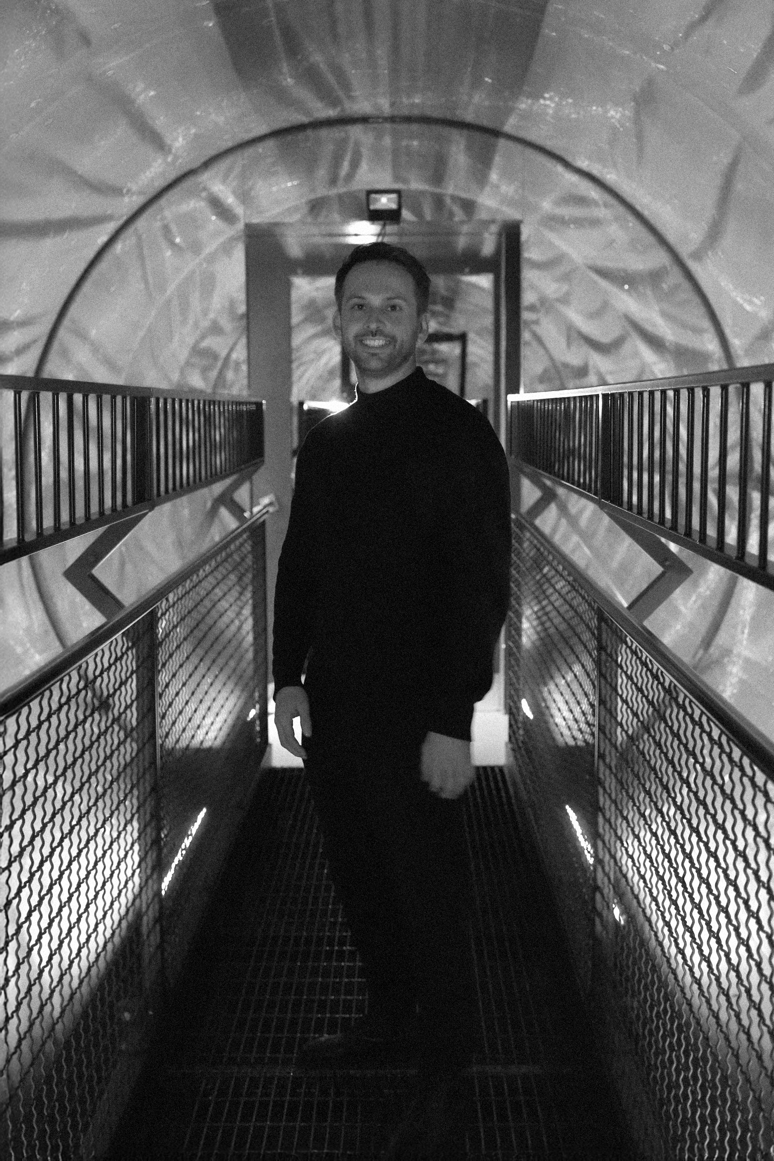 full body portrait of Tobias Füllemann standing in a futuristic tube